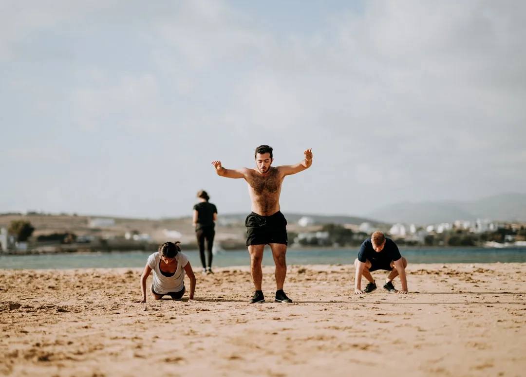 Kyool fitness group high-fiving after completing a workout training session