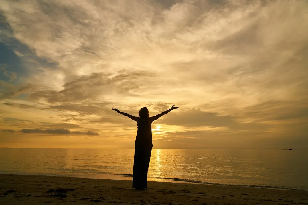 Woman practicing yoga at sunrise outdoors with Kyool fitness accountability